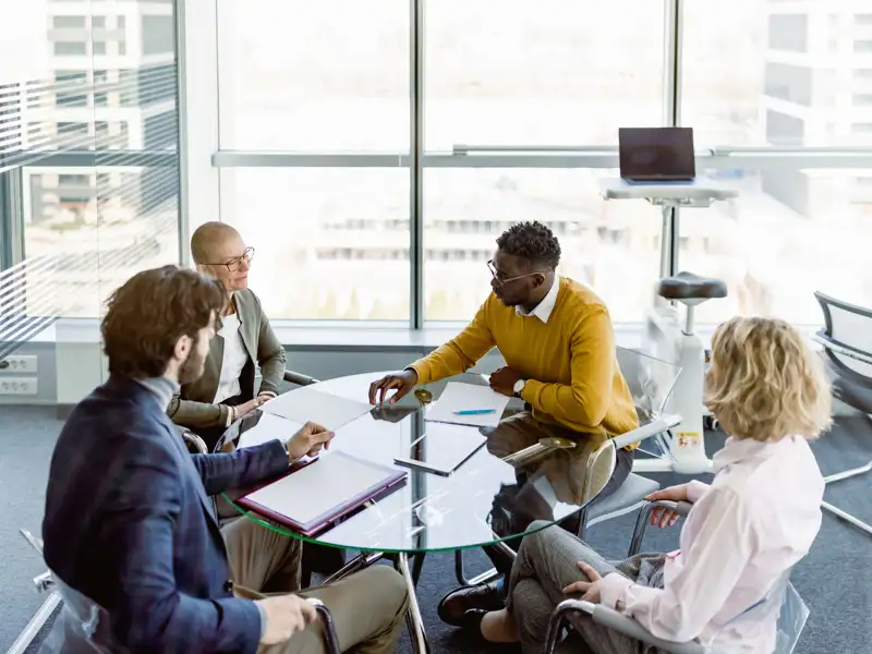 Coworkers in a glass office room.